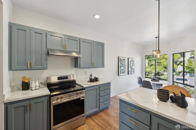 112 S Lake Merced Hls, San Francisco, CA 94132 - kitchen with stainless steel range with electric stovetop, under cabinet range hood, light wood-type flooring, light stone countertops, and hanging light fixtures