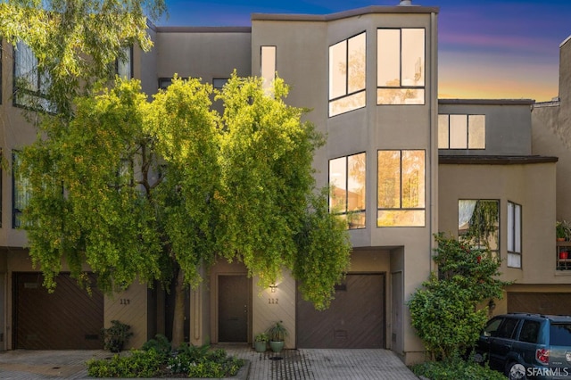 112 S Lake Merced Hls, San Francisco, CA 94132 - view of front of home with a garage, decorative driveway, and stucco siding