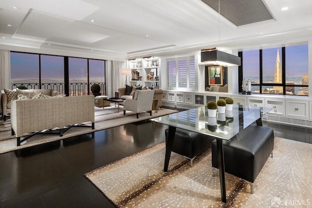 dining area with expansive windows, a tray ceiling, and ornamental molding