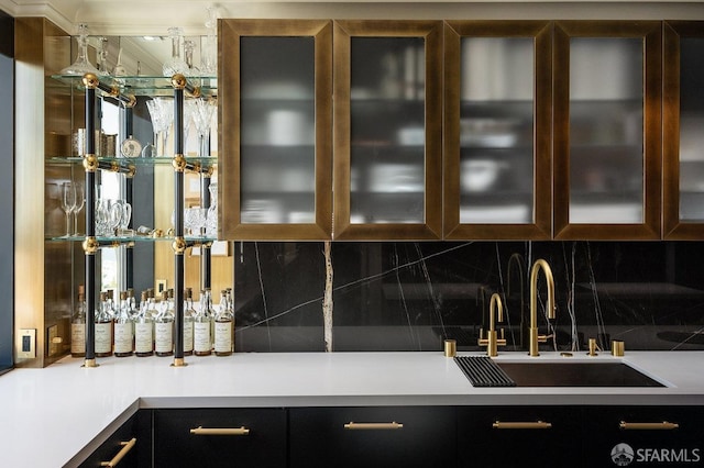 bar featuring sink and backsplash