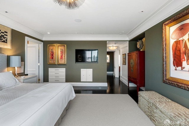 bedroom featuring crown molding and dark wood-type flooring