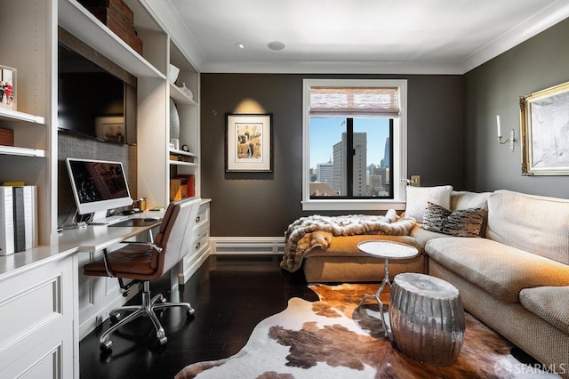 office space featuring baseboard heating, built in shelves, dark hardwood / wood-style floors, and crown molding