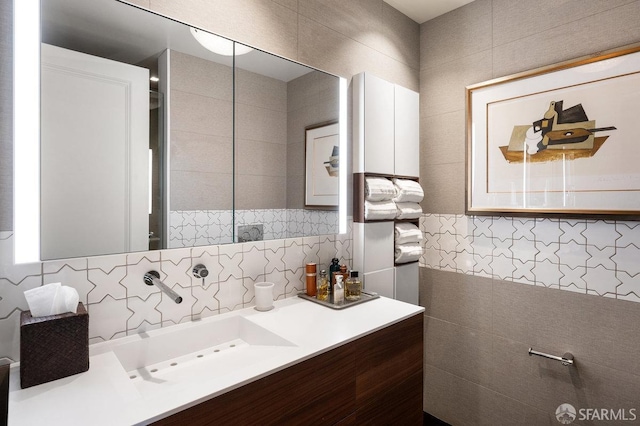 bathroom with vanity and tile walls