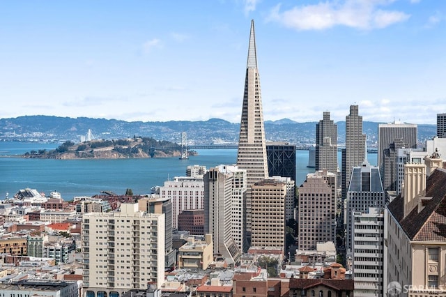 property's view of city featuring a water and mountain view