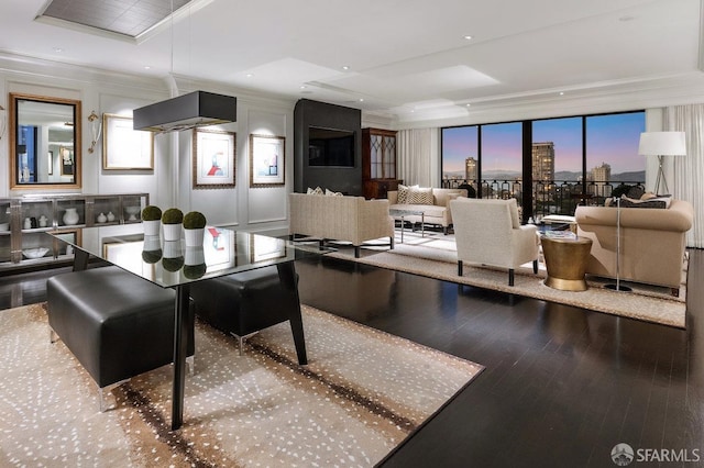 dining area featuring a wall of windows, crown molding, and hardwood / wood-style floors