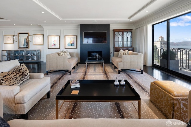 living room with crown molding and a raised ceiling