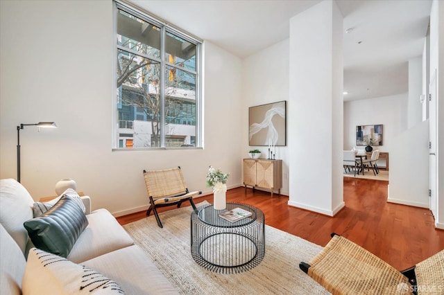 living area with wood finished floors and baseboards