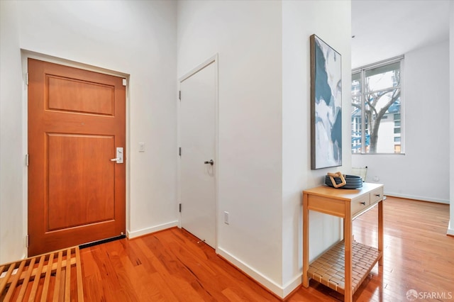 entryway featuring light wood-style flooring and baseboards