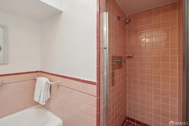 232 Talbert St, San Francisco, CA 94134 - full bathroom featuring a shower stall, a bath, tile walls, and wainscoting