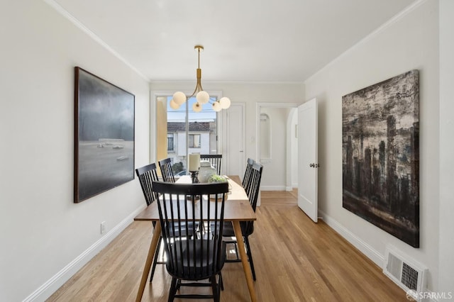 232 Talbert St, San Francisco, CA 94134 - dining area with ornamental molding, light wood-style floors, baseboards, and a chandelier