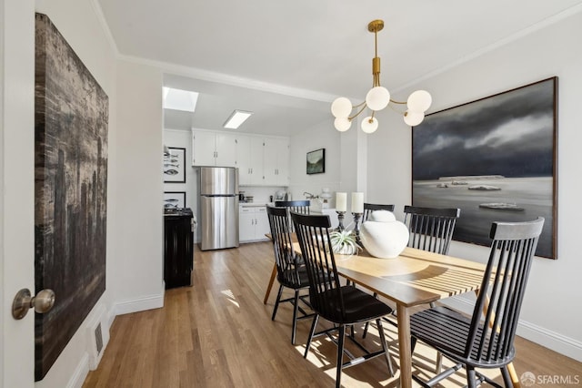 232 Talbert St, San Francisco, CA 94134 - dining space featuring light wood-type flooring, a chandelier, ornamental molding, baseboards, and a skylight