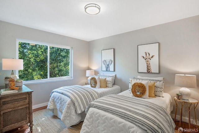 bedroom featuring wood finished floors and baseboards