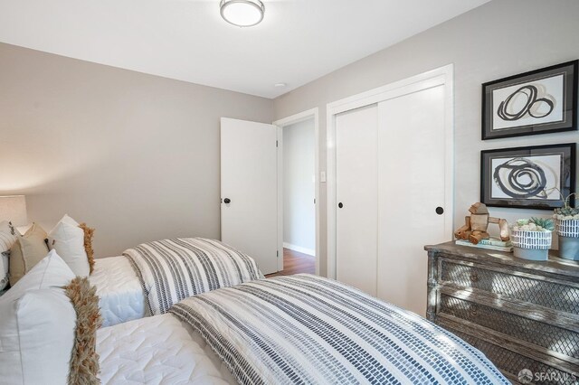 bedroom featuring a closet and wood finished floors