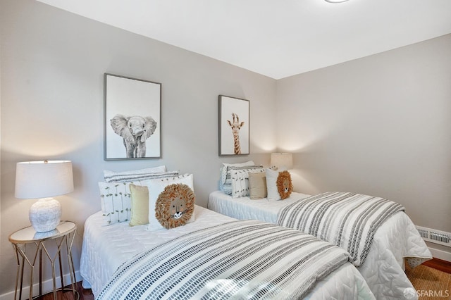 bedroom featuring baseboards and wood finished floors