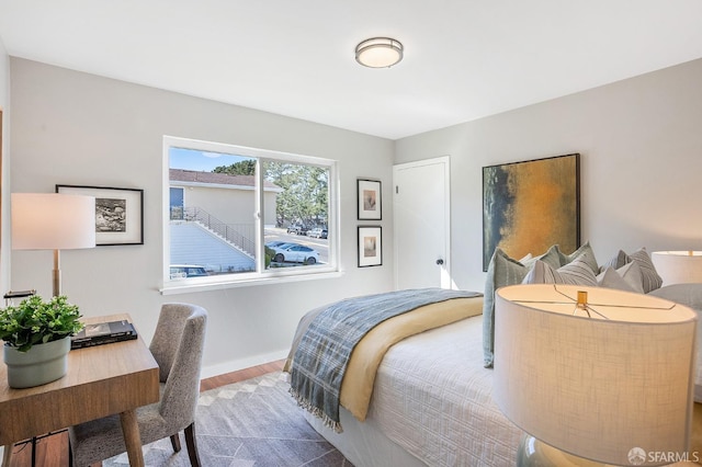 bedroom with baseboards and wood finished floors