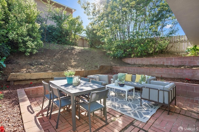 view of patio / terrace with a fenced backyard, outdoor lounge area, and outdoor dining space