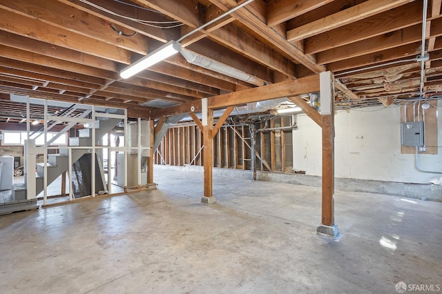 basement featuring electric panel and stairway