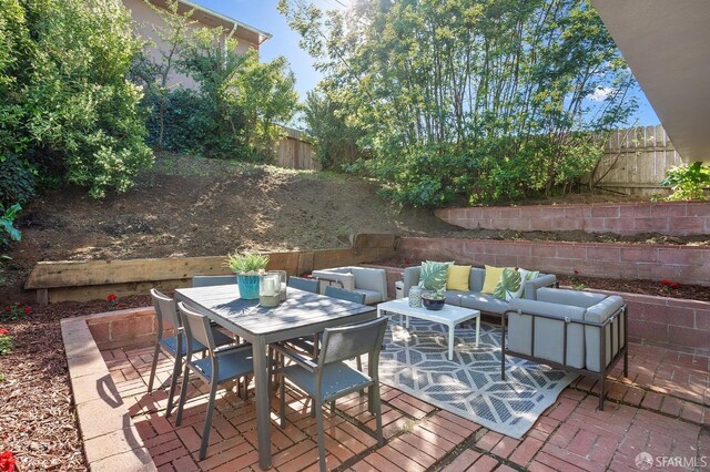 view of patio / terrace with outdoor dining space, a fenced backyard, and an outdoor hangout area