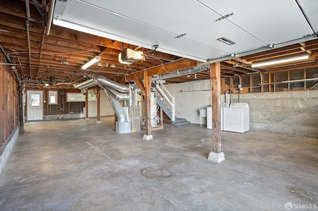 garage with washer / clothes dryer, visible vents, and a garage door opener