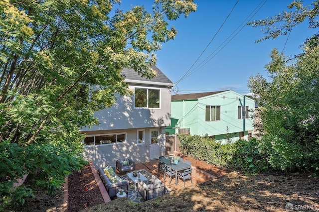 rear view of property with a patio and roof with shingles