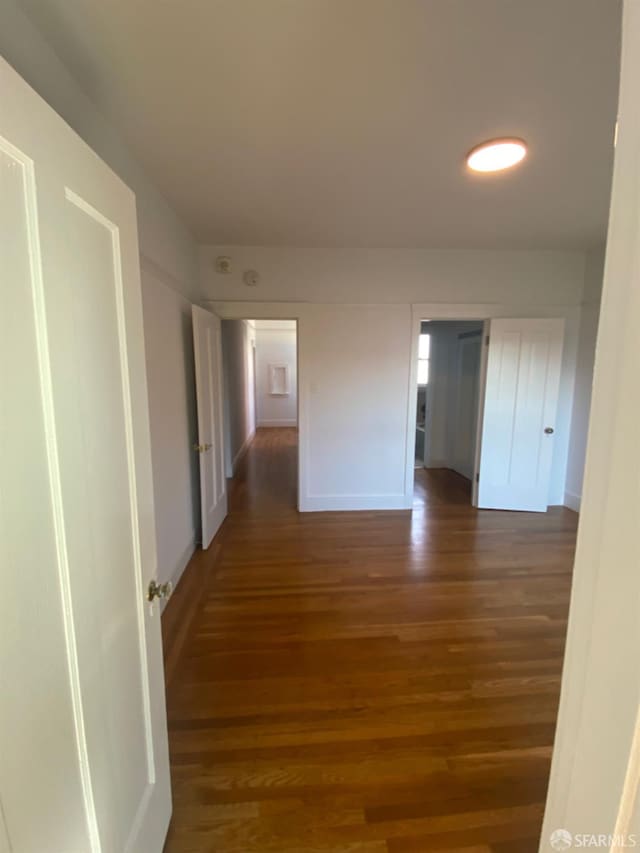 hall with dark hardwood / wood-style flooring