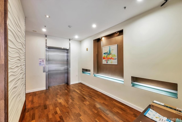 interior space with elevator, baseboards, dark wood-style floors, and recessed lighting