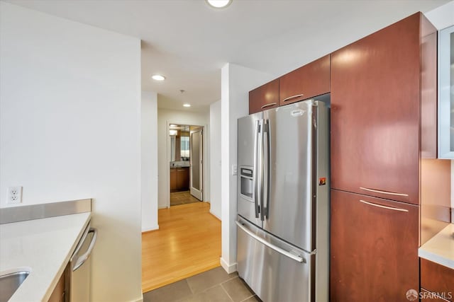 kitchen featuring tile patterned flooring, stainless steel appliances, light countertops, and recessed lighting