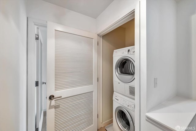 washroom with laundry area and stacked washer / dryer