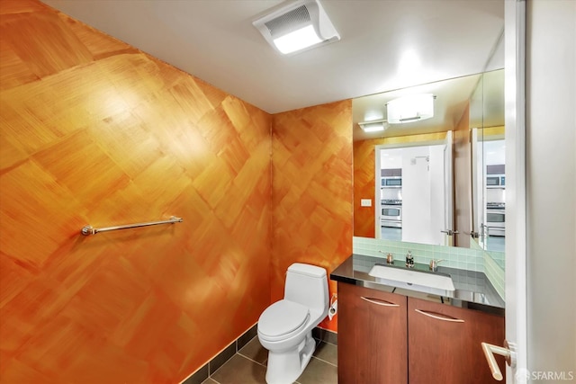 bathroom with visible vents, vanity, toilet, and tile patterned floors