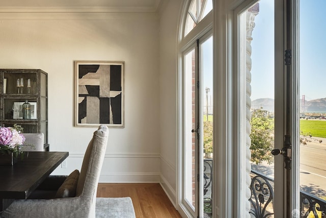 interior space featuring wood-type flooring and ornamental molding