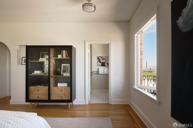 bedroom featuring hardwood / wood-style flooring and crown molding