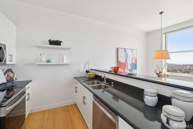 355 Buena Vista E Avenue 605W, San Francisco, CA 94117 - kitchen with white cabinets, dark countertops, appliances with stainless steel finishes, a sink, and light wood-style flooring