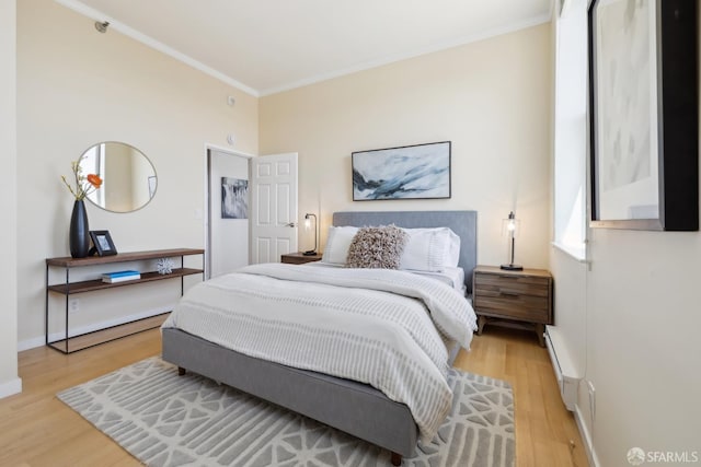 355 Buena Vista E Avenue 605W, San Francisco, CA 94117 - bedroom featuring baseboards, ornamental molding, a baseboard heating unit, and light wood finished floors