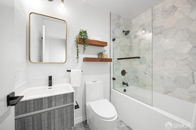 full bathroom featuring tiled shower / bath, vanity, and toilet