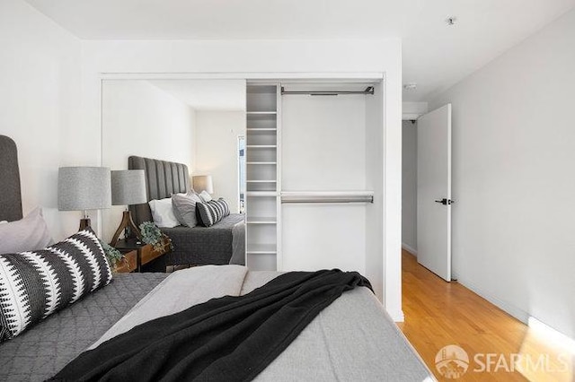 bedroom featuring wood-type flooring and a closet