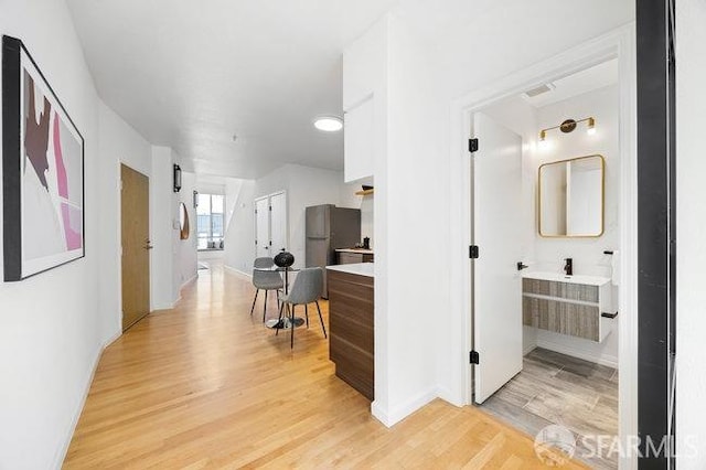 hall with light hardwood / wood-style floors