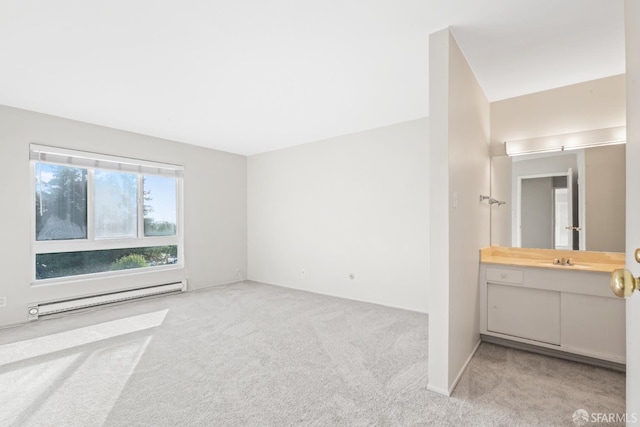 816 N Delaware St Unit 409, San Mateo, CA 94401 - unfurnished bedroom featuring a baseboard radiator, carpet flooring, and a sink