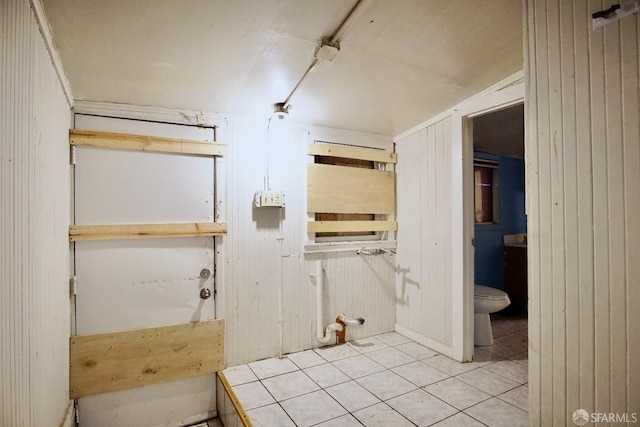 3838 Buell St, Oakland, CA 94619 - bathroom with toilet, wood walls, and tile patterned flooring