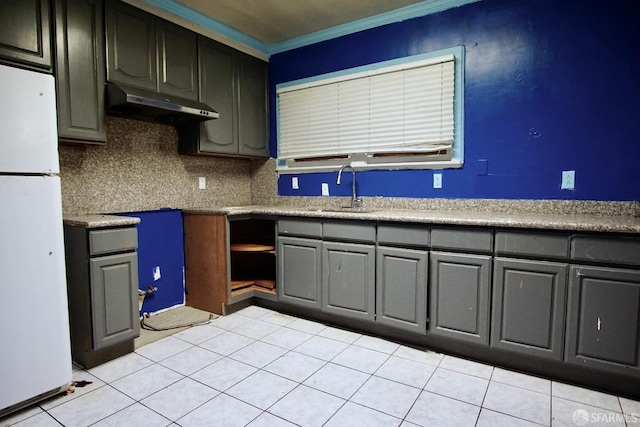 3838 Buell St, Oakland, CA 94619 - kitchen featuring crown molding, tasteful backsplash, a sink, freestanding refrigerator, and under cabinet range hood