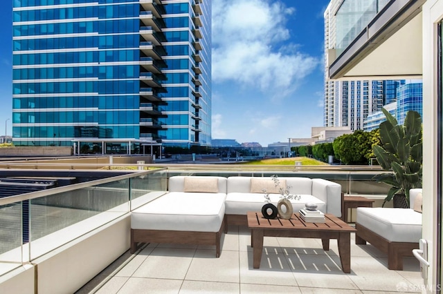 view of patio featuring a view of city, an outdoor living space, and a balcony