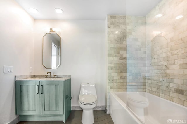 full bathroom featuring toilet, tub / shower combination, vanity, tile patterned flooring, and baseboards