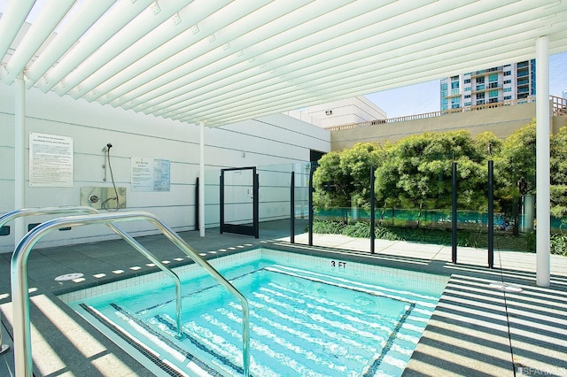 view of swimming pool featuring fence