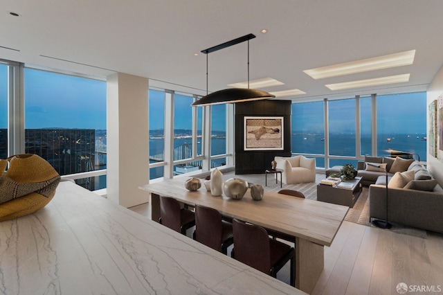 181 Fremont St Unit 62B, San Francisco, CA 94105 - dining area with expansive windows, a water view, and wood finished floors