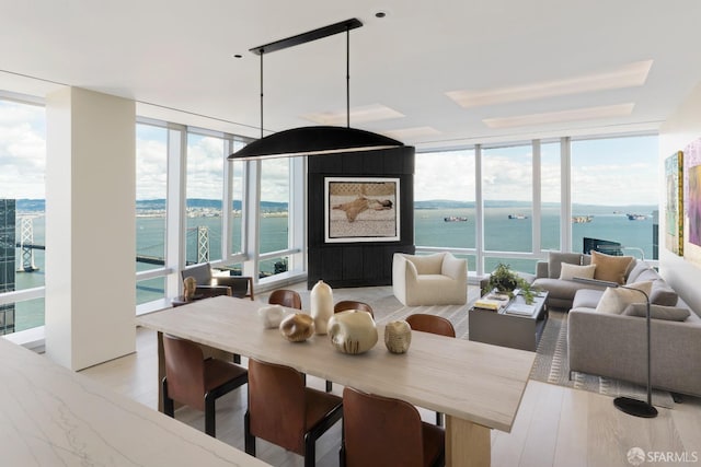 181 Fremont St Unit 62B, San Francisco, CA 94105 - dining space with a wall of windows, a water view, and light wood finished floors