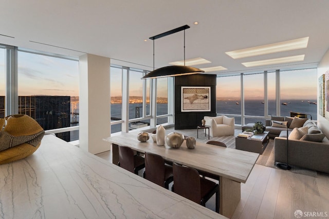 181 Fremont St Unit 62B, San Francisco, CA 94105 - dining room featuring floor to ceiling windows, a water view, and wood finished floors