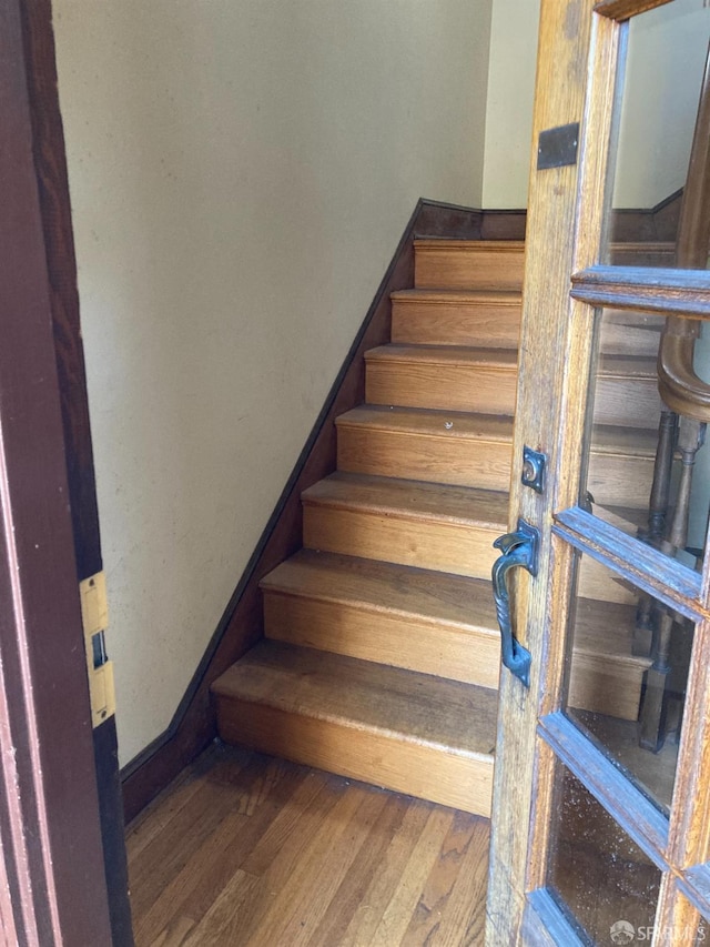 stairway with wood-type flooring