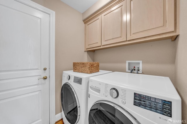 laundry room featuring washer and clothes dryer and cabinet space