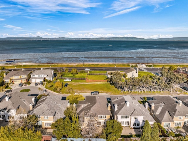 drone / aerial view with a residential view and a water and mountain view