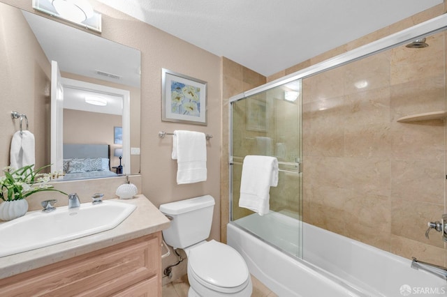 ensuite bathroom featuring visible vents, toilet, vanity, enclosed tub / shower combo, and ensuite bath