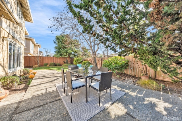 view of patio with outdoor dining space and a fenced backyard